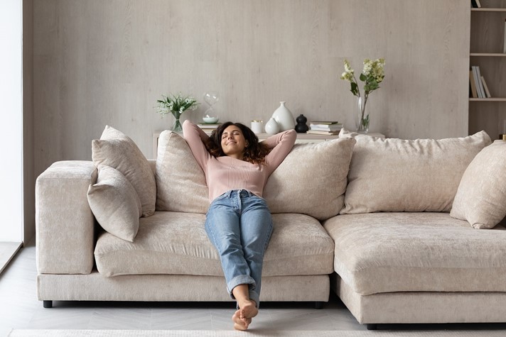 Woman relaxing on the couch in her well-ventilated home