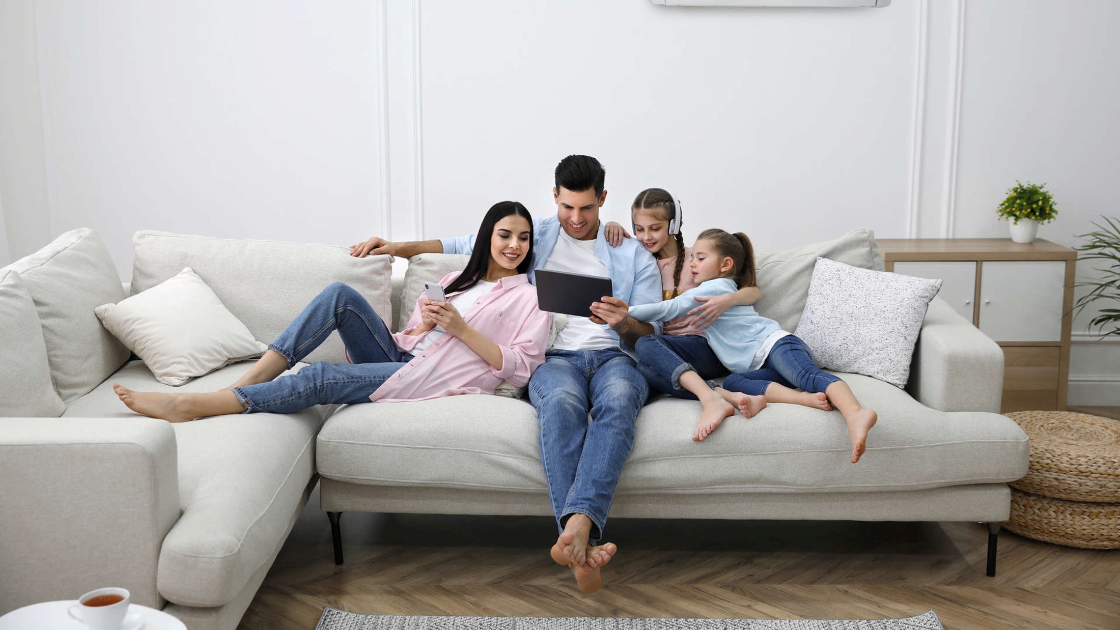 Smart home ventilation – happy family enjoying a ventilated living room